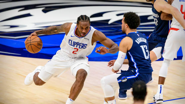 May 28, 2021; Dallas, Texas, USA; LA Clippers forward Kawhi Leonard (2) brings the ball up court past Dallas Mavericks guard Jalen Brunson (13) during the second half in game three in the first round of the 2021 NBA Playoffs at American Airlines Center. Mandatory Credit: Jerome Miron-USA TODAY Sports